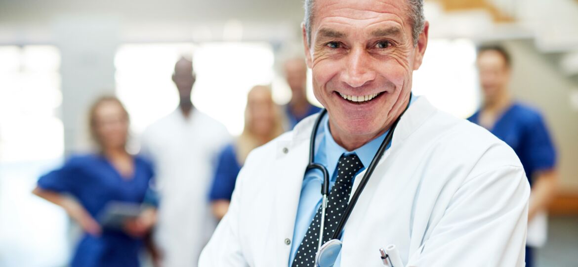 Medical specialist smiling standing with arms crossed